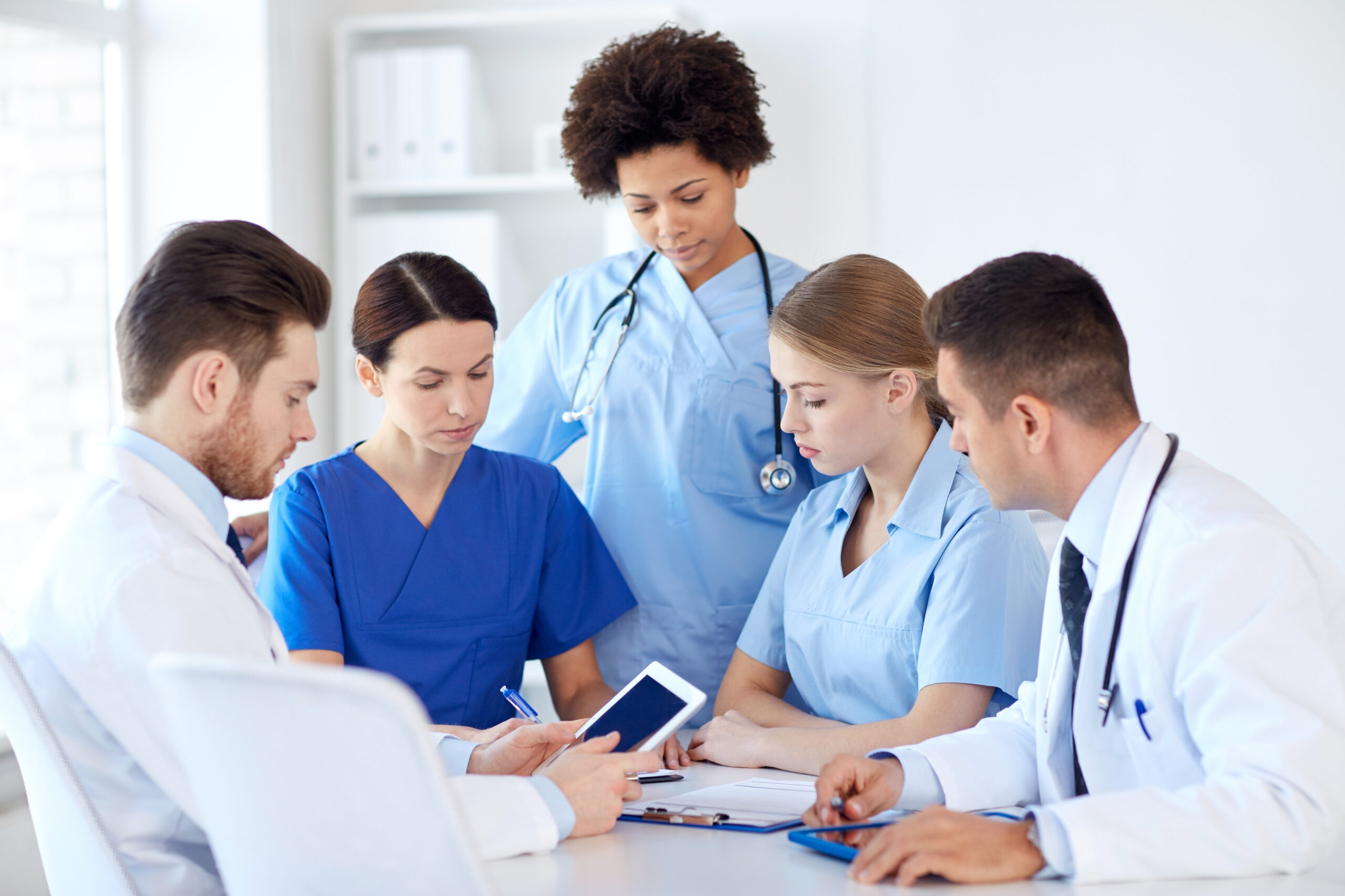 group of doctors with tablet pc at hospital