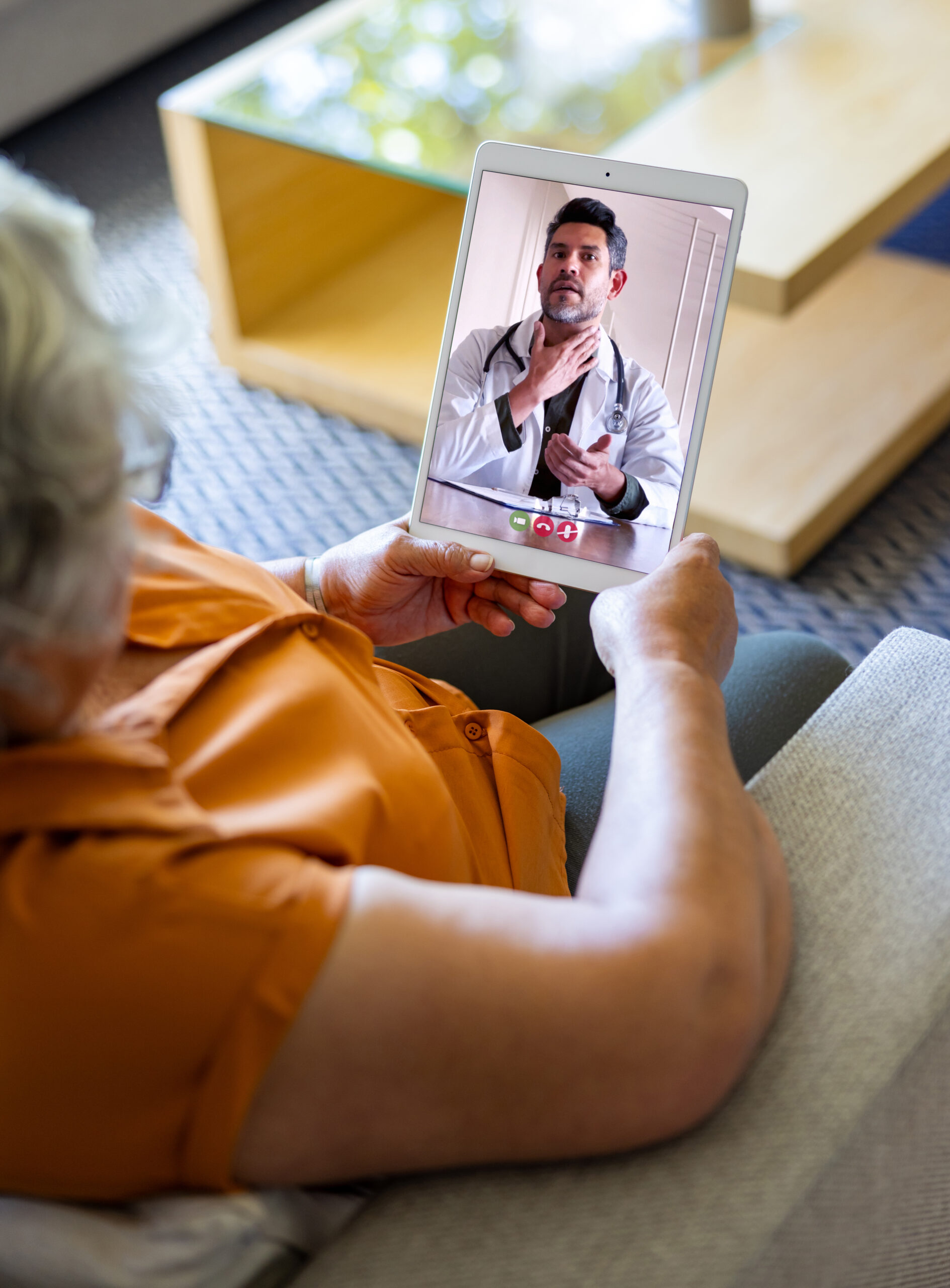 Woman at home talking to her doctor on a video call